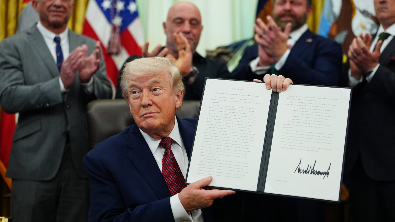 Trump showing signed executive order with Joe Rogan and others in the background, to fast-track psychedlics by giving $50 million to FDA for making ibogaine, psilocybin and other psychedelics available.